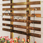 Carbonised wooden lattice trellis with hanging string lights