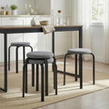Pair of dark grey round cushioned backless stools with black legs