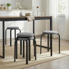 Pair of dark grey round cushioned backless stools with black legs