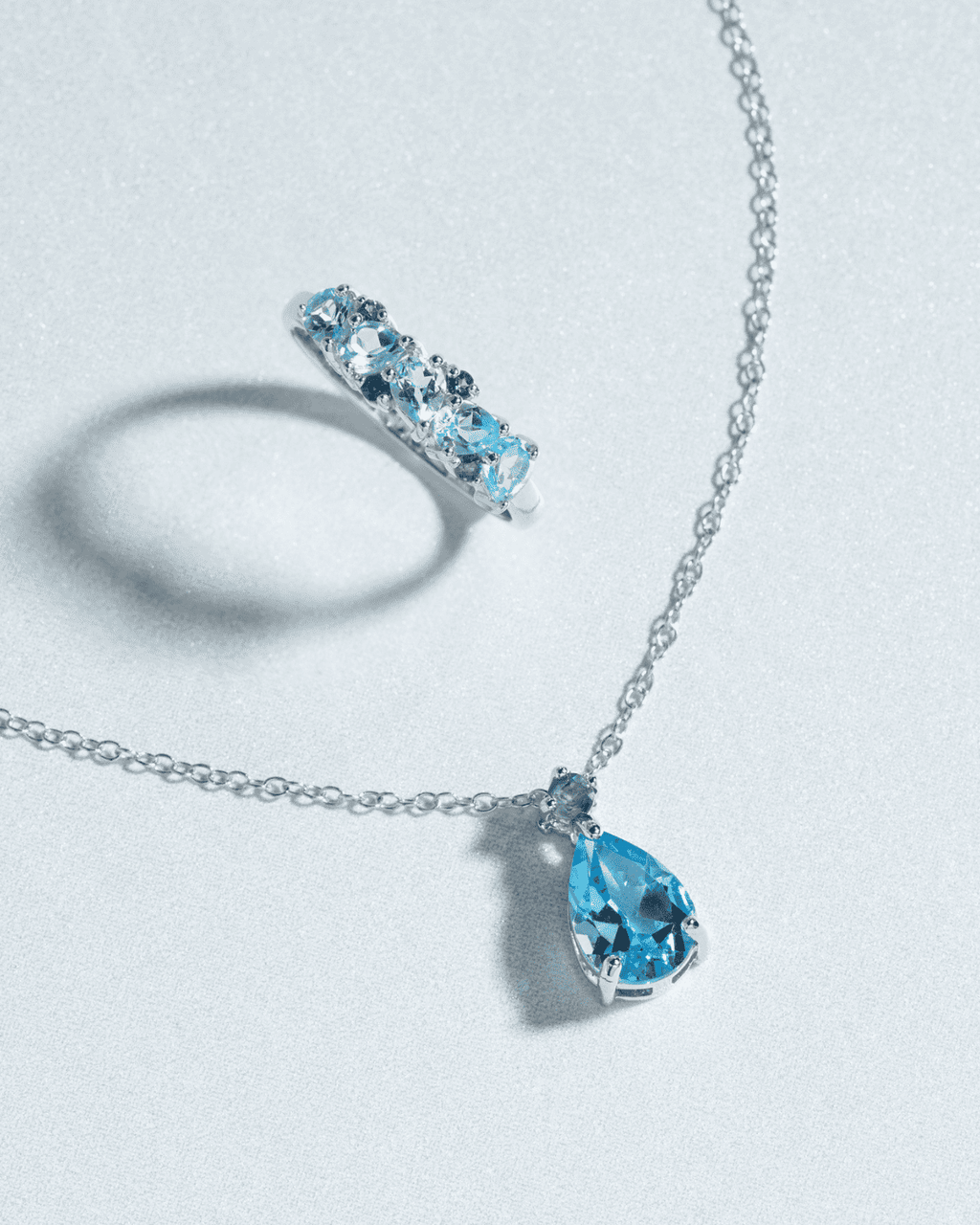 Sterling silver necklace with pear-cut blue teardrop pendant and matching ring