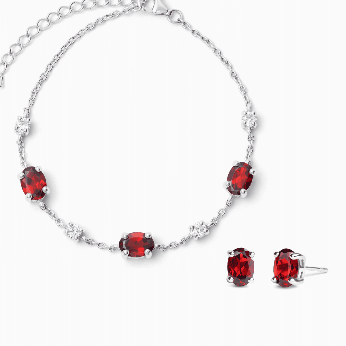 Sterling silver necklace with oval red gemstones and small clear stone accents, linked chain