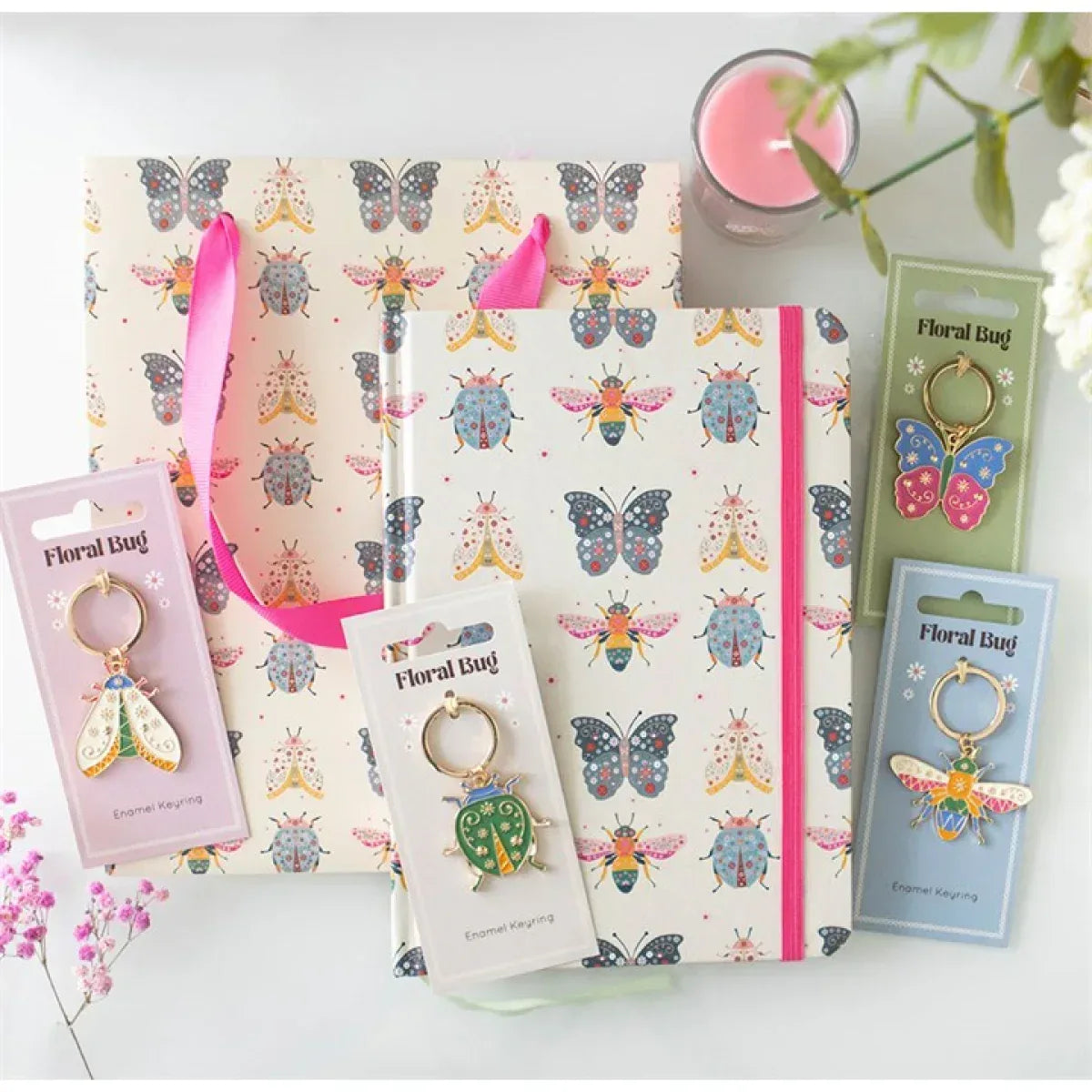 Floral bug print gift bag with pink handles beside matching Floral Bug cards