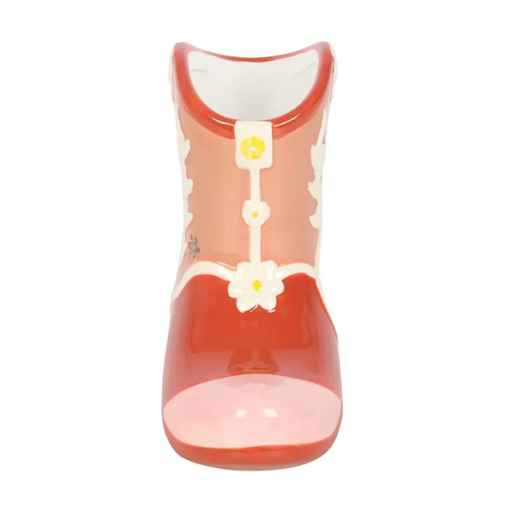 Orange cowboy boot-shaped wax warmer with white floral accents on front