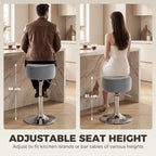 Grey adjustable swivel bar stool with round cushioned seat and chrome footrest base