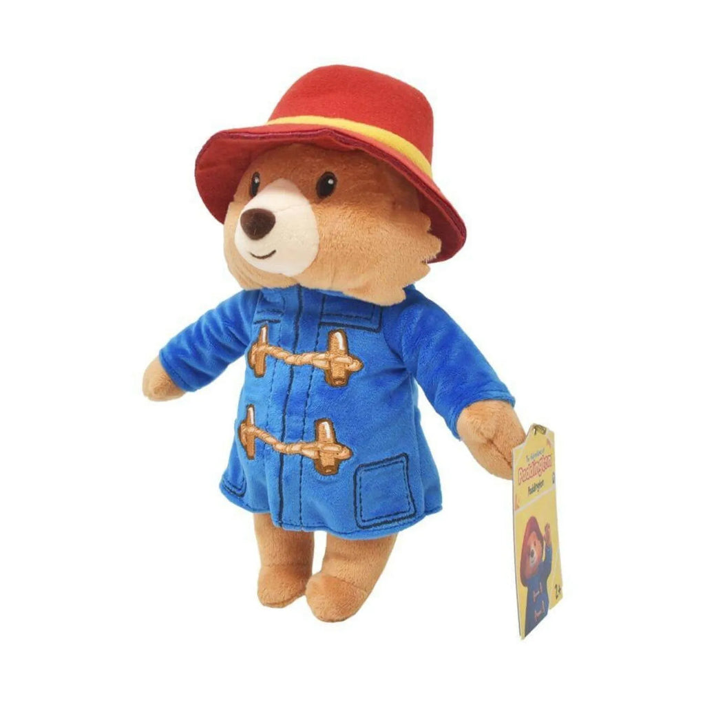 Paddington plush bear in red hat and blue duffel coat with gold toggles, side view