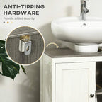 White bathroom sink cabinet with anti-tip hardware detail near side wall.
