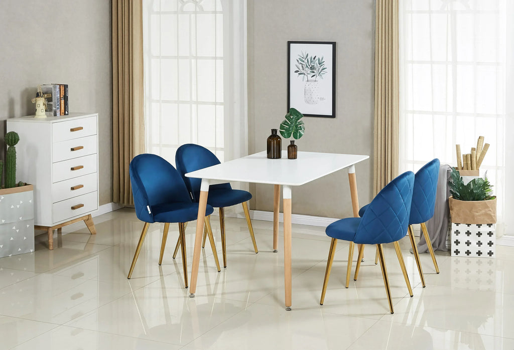 White dining table with four blue upholstered chairs and wooden legs