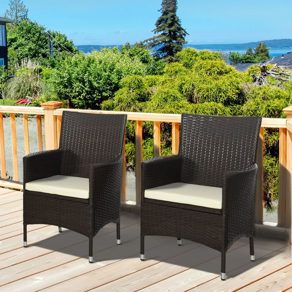 Pair of dark brown woven patio armchairs with cream cushions and armrests