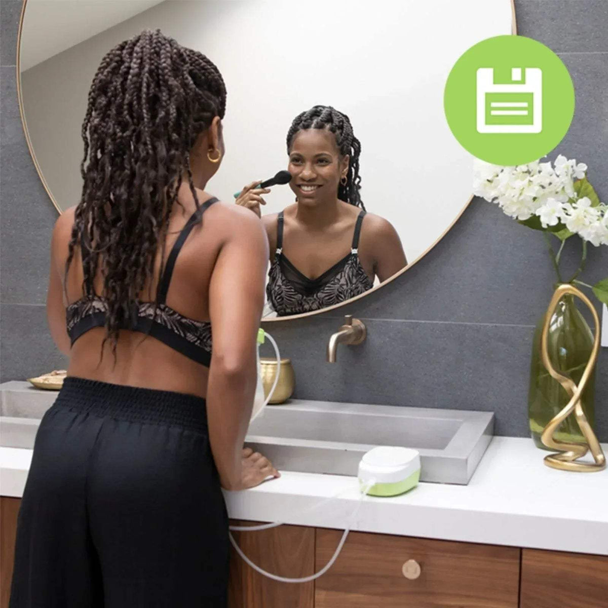 Double electric breast pump used with two flanges and tubing at the sink
