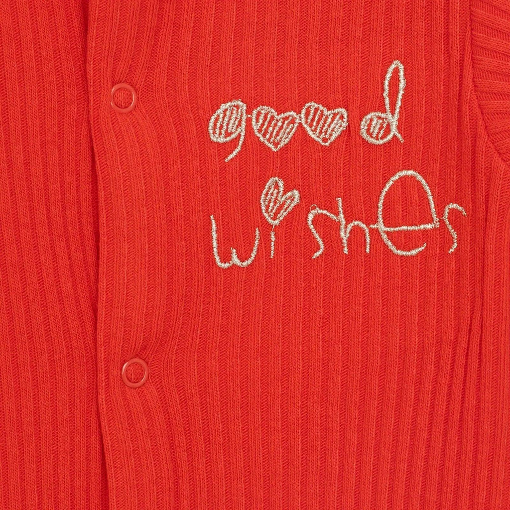 Wish embroidery detail on orange rib-knit jumpsuit