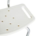 White shower stool seat close-up with textured anti-slip surface and drainage holes.