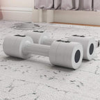 White adjustable dumbbells lying on the floor with round weight ends and handle