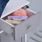 Open drawer of white and grey bathroom cabinet with silver knob and stored toiletries