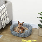 Grey wicker pet sofa bed with beige cushion, shown with a small dog