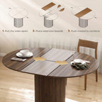 Extendable round dining table in dark walnut with extension leaves pulled out