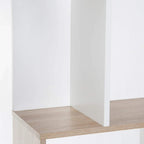 Close-up of lower shelf on S-shaped bookshelf with white side panels and oak base