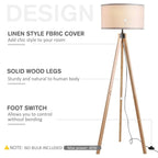 Beige fabric floor lamp with light wood legs, black base, and visible foot switch