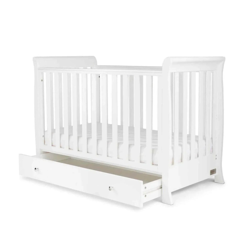 White mini cot bed with open side rail and mattress base with side drawer