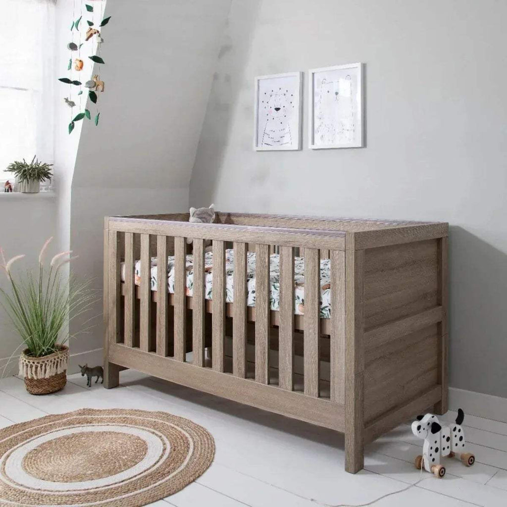 Oak 3-in-1 cot bed with slatted sides and rounded corners, raised rail and legs