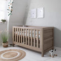 Oak 3-in-1 cot bed with slatted sides and rounded corners, raised rail and legs