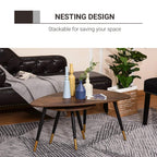 Walnut round coffee table set with black legs and gold tips on patterned rug