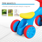 Blue toddler balance bike with yellow padded seat and red wheel rims