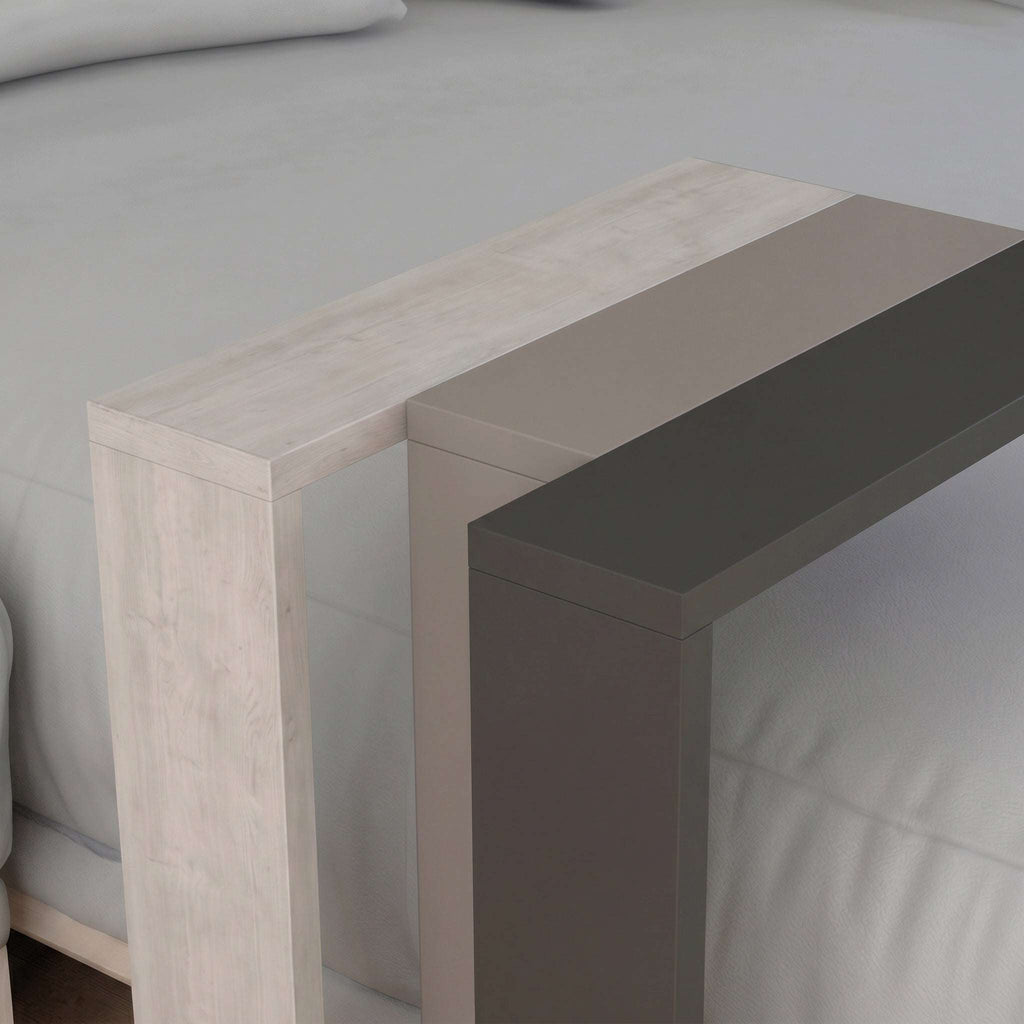 Close-up of two-tone C-shaped side table frame in light wood and dark tone