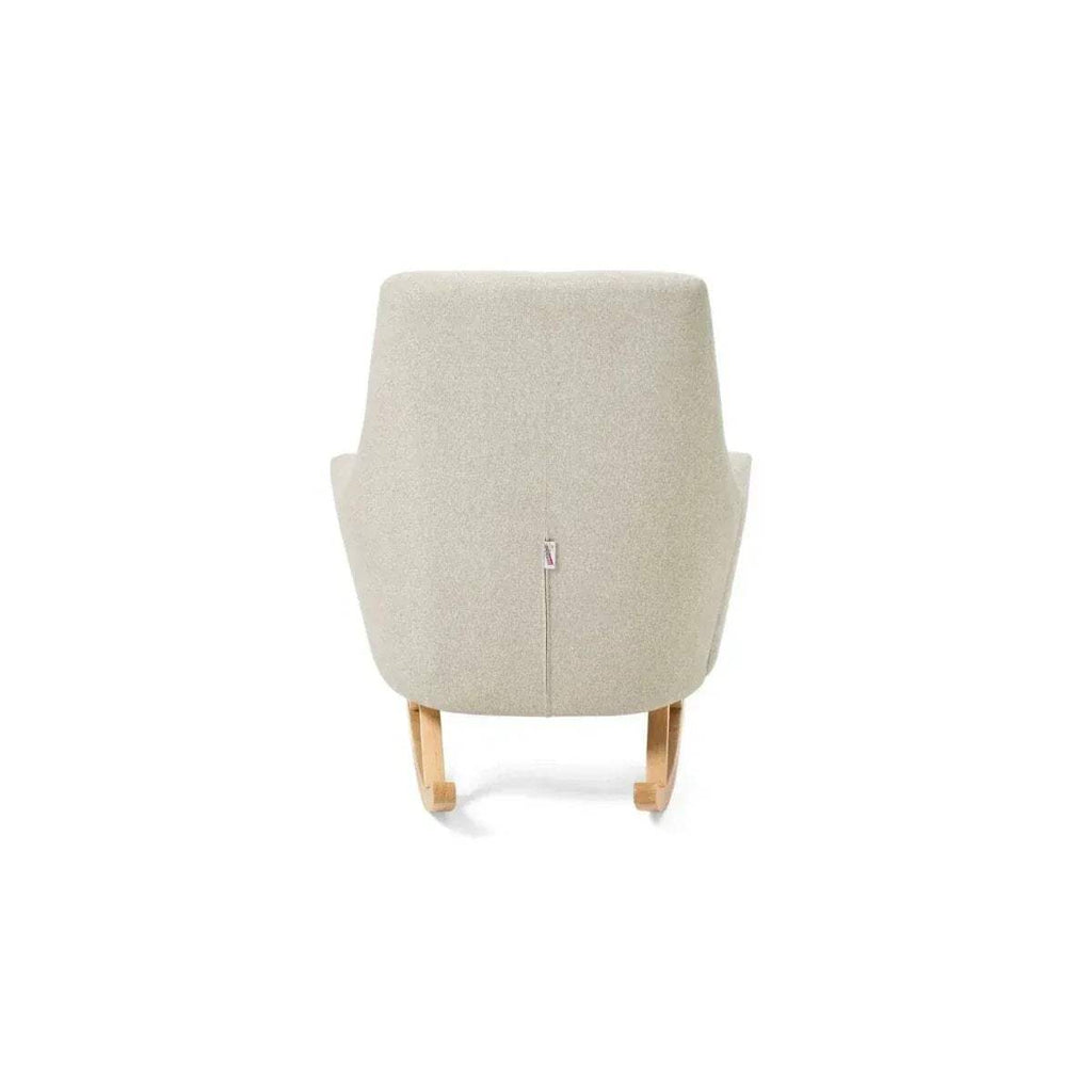 Back view of beige upholstered rocking chair with fabric panel and wooden rockers