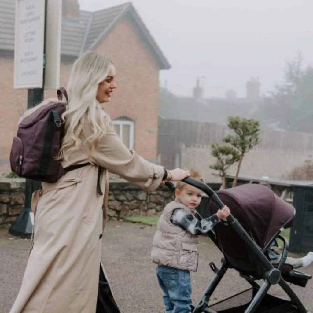 Carbonite single stroller with dark canopy and seat, used for a walk