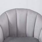 Grey velvet armchair back with vertical channel stitching and rounded top
