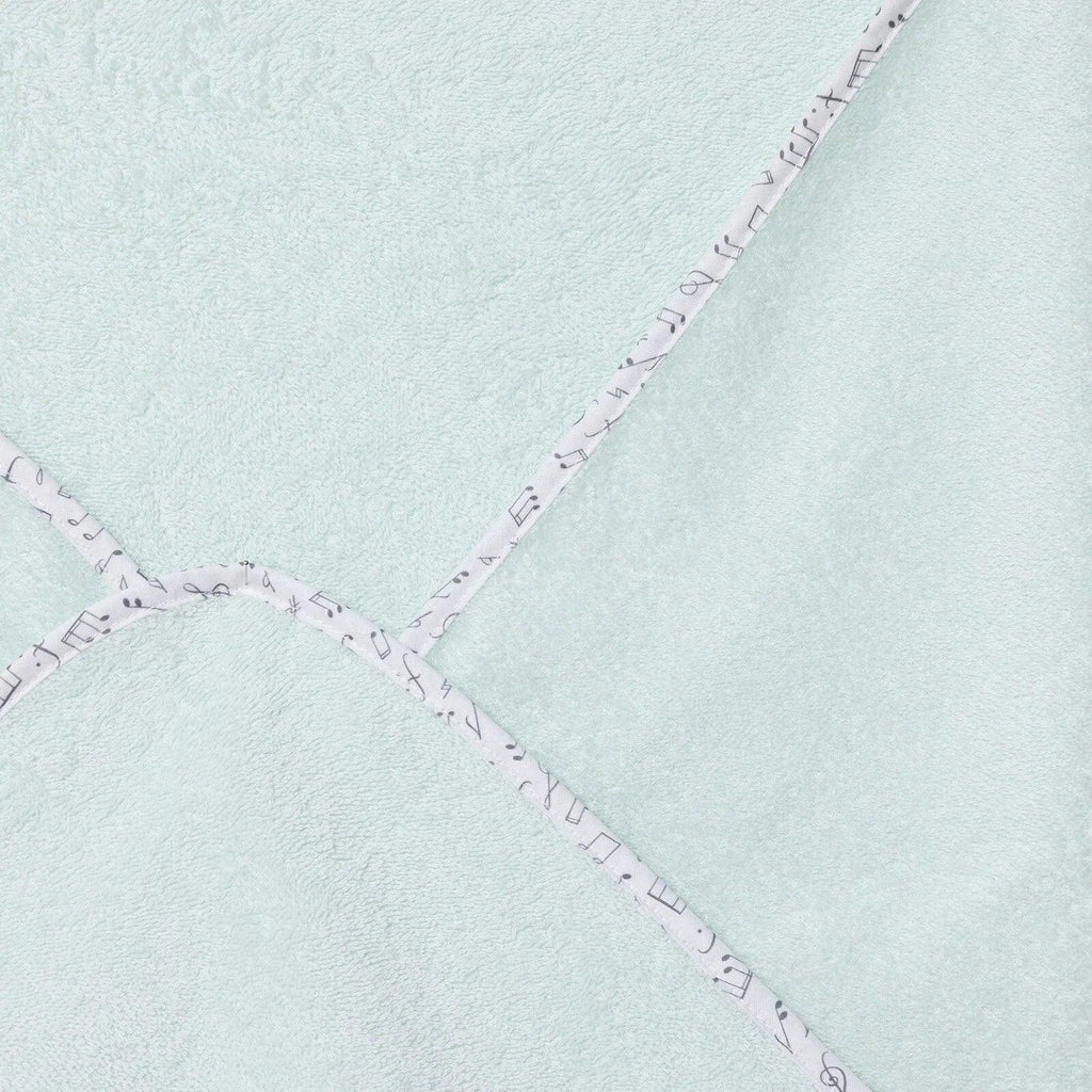 Baby bath towel seam close-up, light blue with purple stitched decorative trim