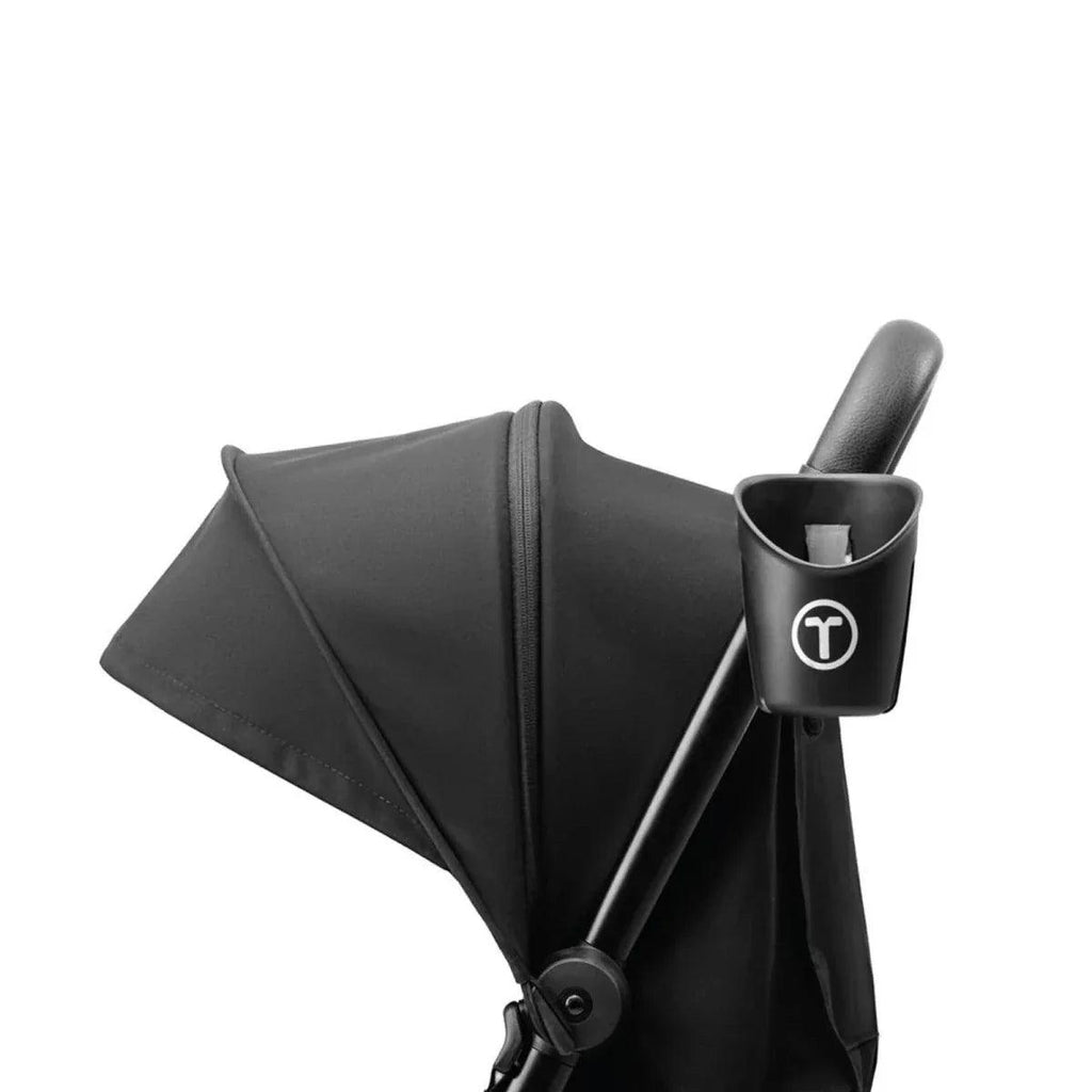 Black cup holder attached near stroller canopy frame