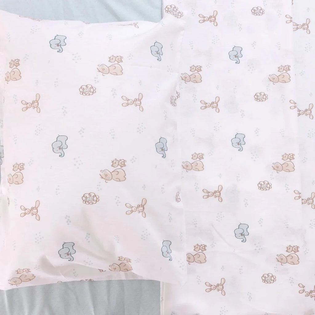 Folded duvet cover with repeating pale blue and beige animal print pattern