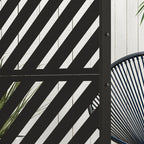 Black metal privacy screen corner with diagonal stripe triangle pattern, close-up