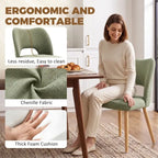 Green chenille dining chair with curved back, thick foam cushion, and light wood legs