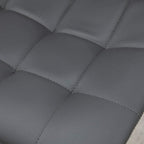 Close-up of grey tufted PU leather bar stool seat with stitched square pattern