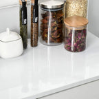 Glossy white sideboard top surface with jars and canisters for storage