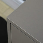 Close-up of grey cabinet corner and drawer edge with smooth laminate finish.