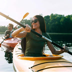 Black padded kayak seat with high backrest and gray cushions on a canoe/kayak