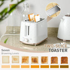 Cream 2-slice toaster with toast slices next to a cream electric kettle