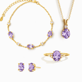 Gold vermeil jewelry set with purple gemstone necklace, ring, and stud earrings.
