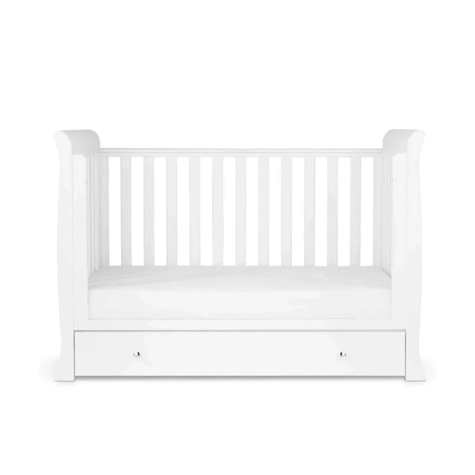 White mini cot with slatted sides and a padded mattress base
