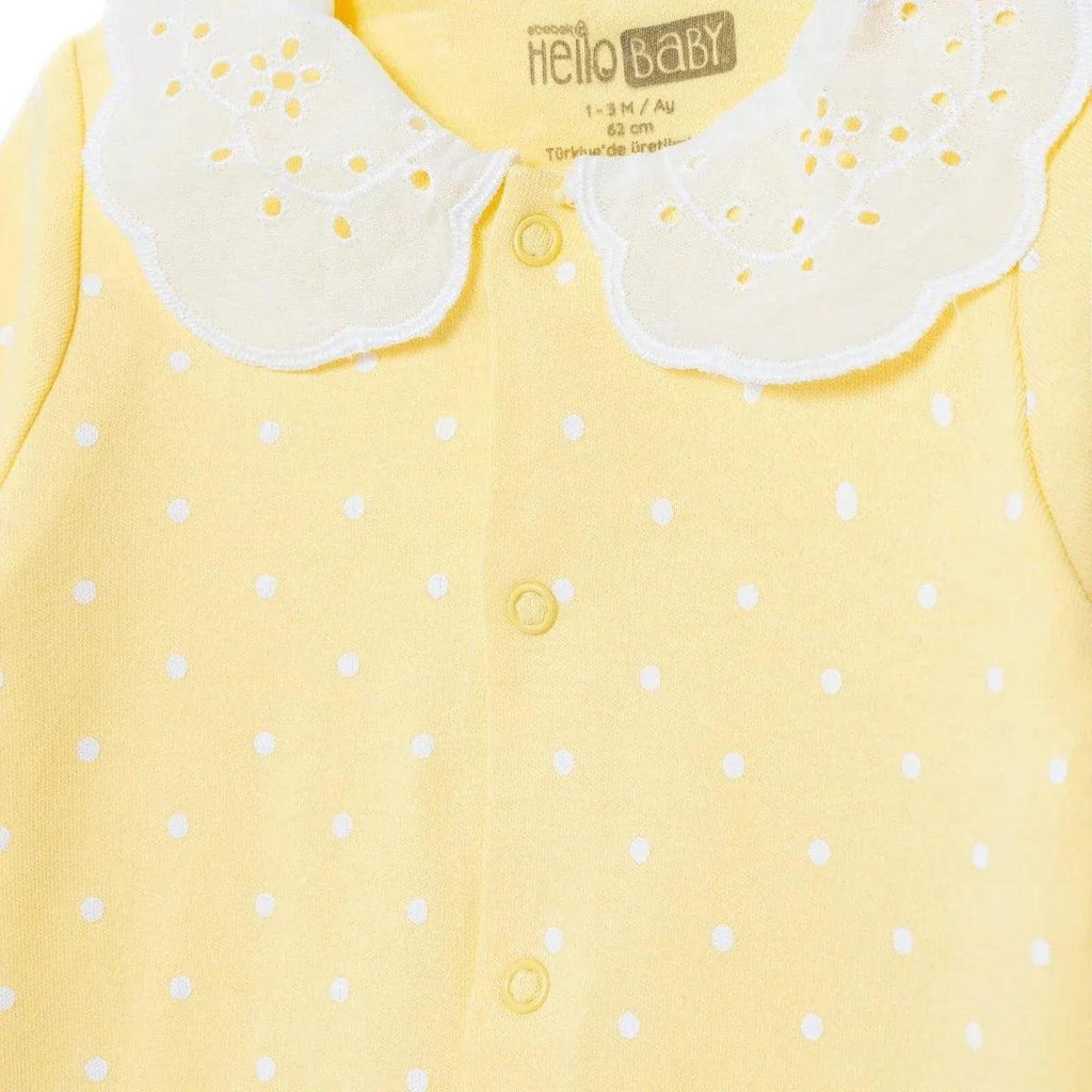 Yellow polka-dot baby sleepsuit with white scalloped collar and front snap buttons