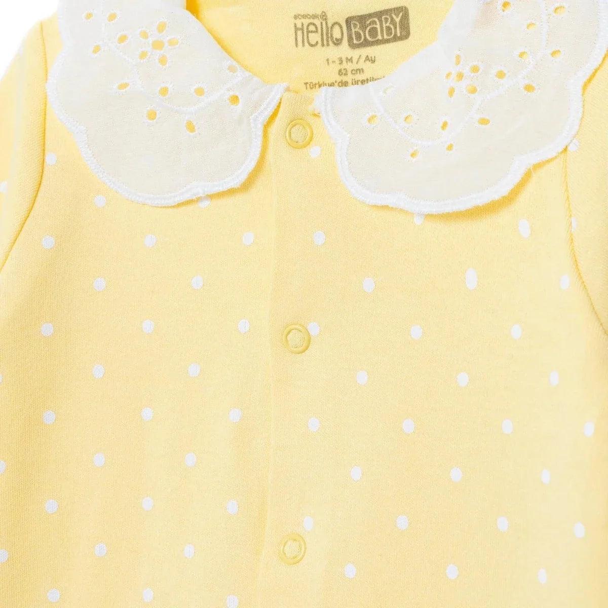Yellow polka-dot baby sleepsuit with white scalloped collar and front snap buttons
