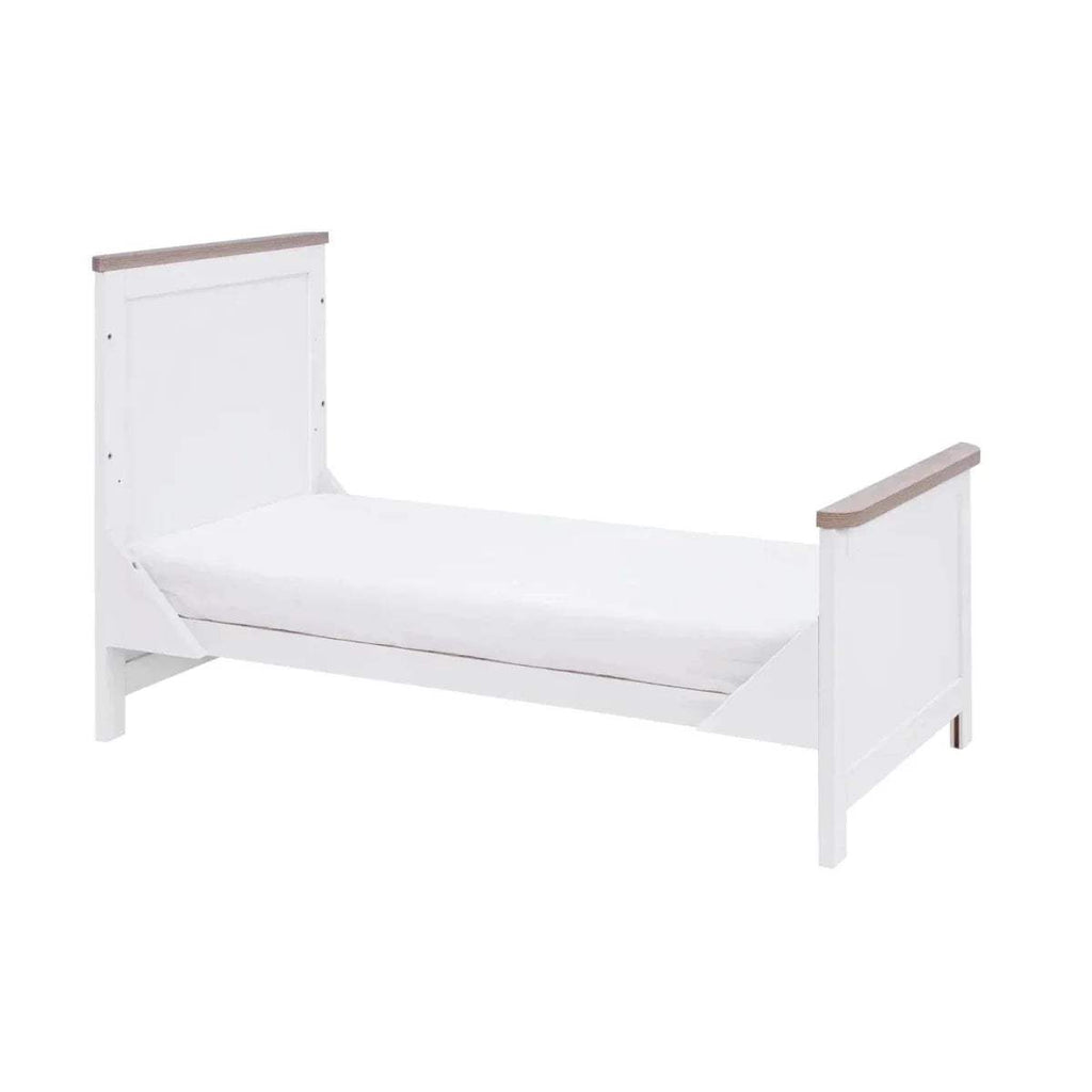 White toddler bed with side guards and raised end panels