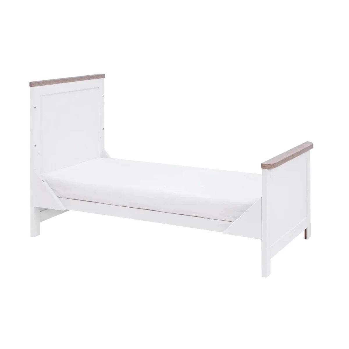 White toddler bed with side guards and raised end panels