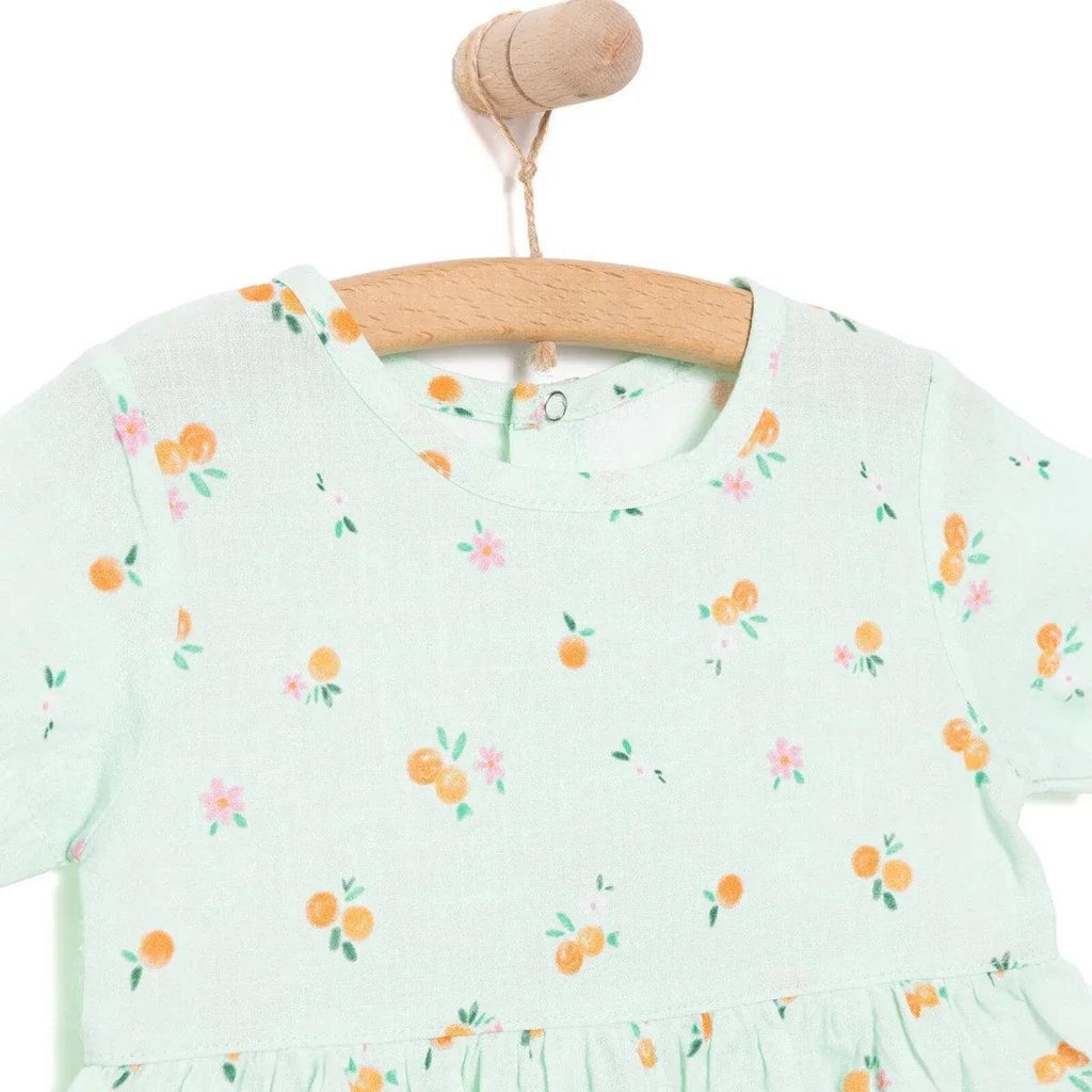 Light blue floral-print neckline with short sleeves, newborn dress on hanger