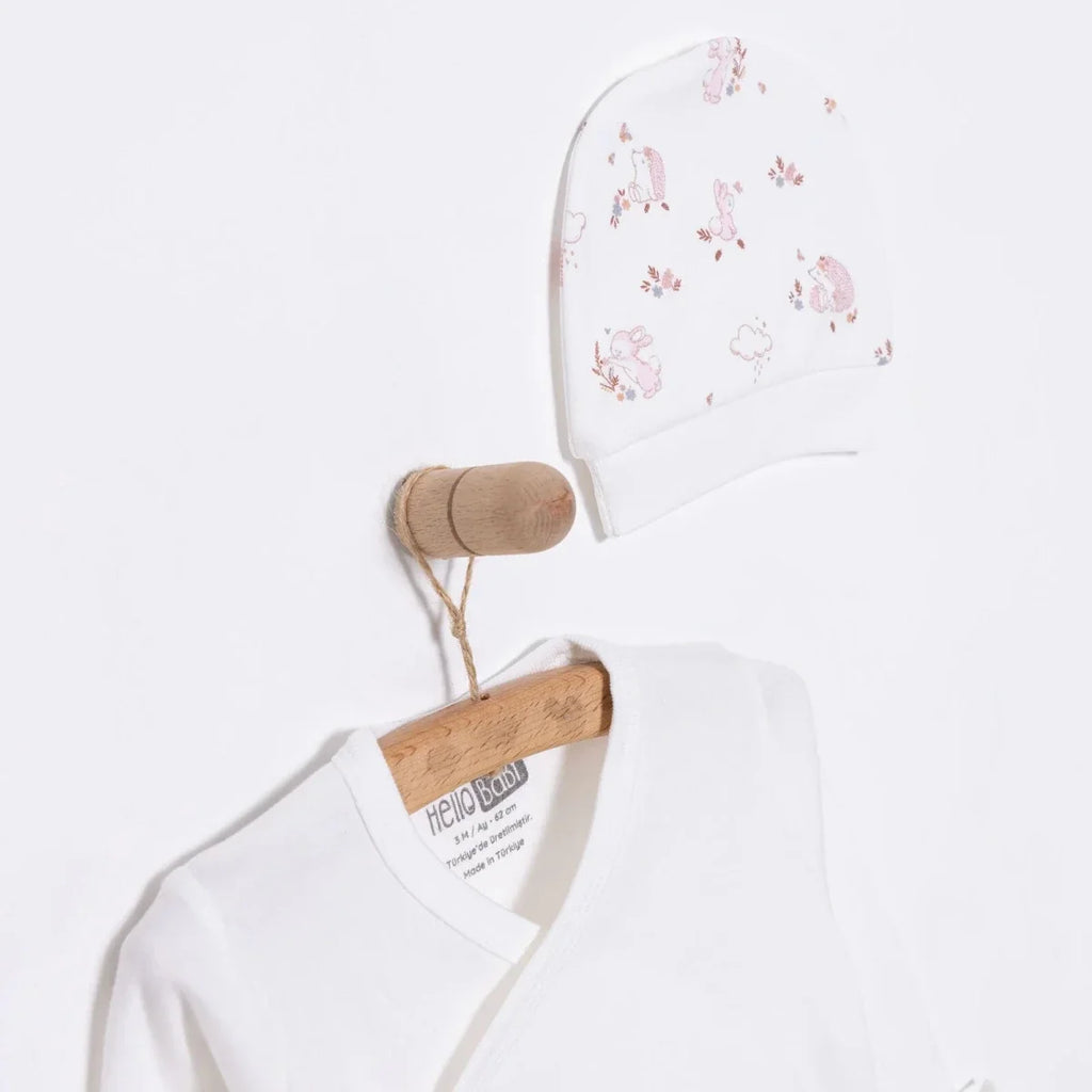 Ecru baby hat and long-sleeve top, each with small pink animal prints