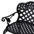 Black cast aluminum garden bench close-up of seat slats and arm scroll detail