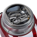 Stainless steel heating head inside clear dome of red cotton candy machine, close-up